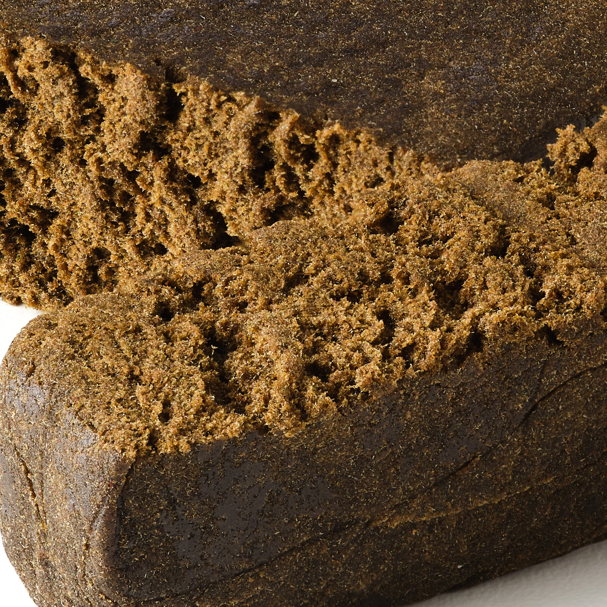 Ivory Lebanese CBD hash showing smooth dense hemp hash with classic pressed appearance