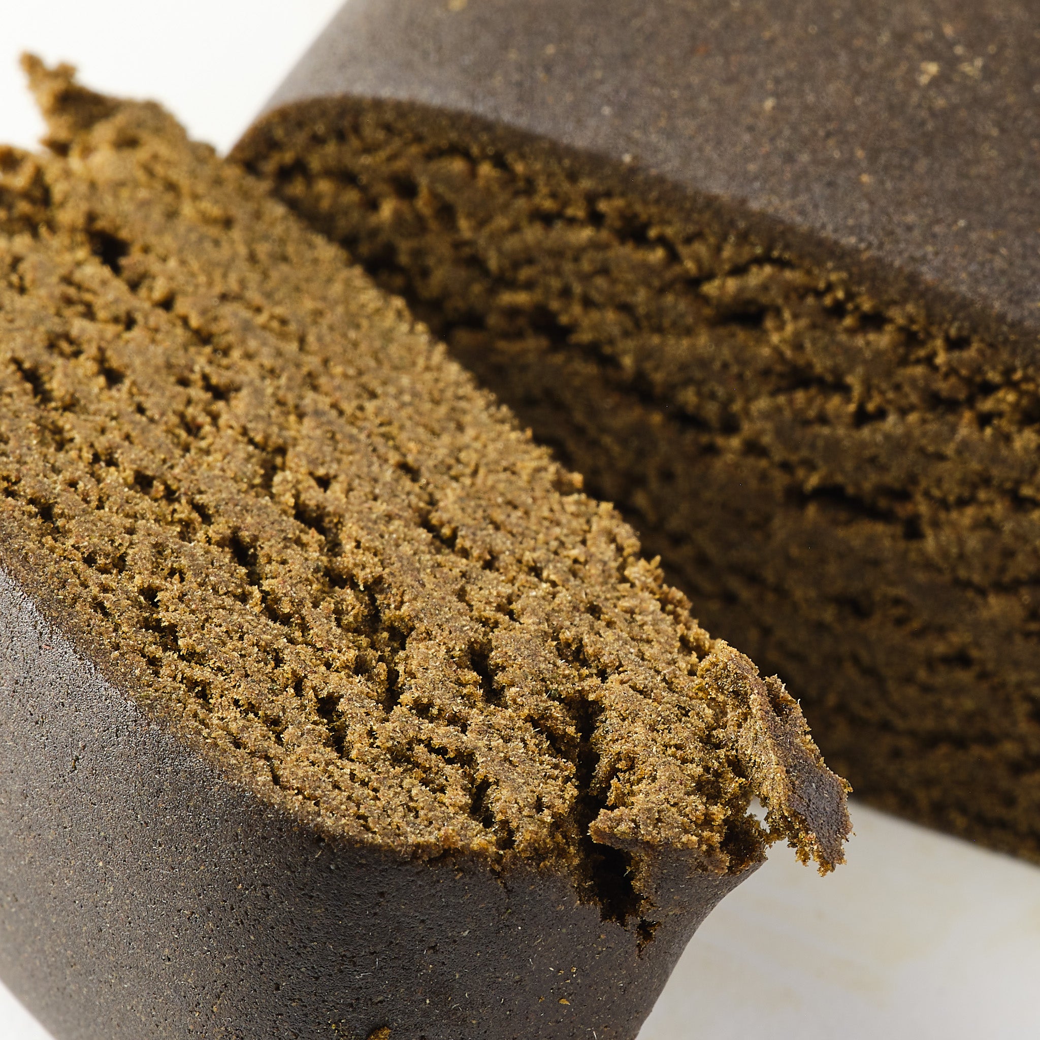Ivory Olivette CBD hash showing dense filtered hemp hash with premium pressed texture
